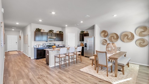 Pecan Creek model home open concept of living room with view of dining room and kitchen.