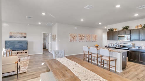 Pecan Creek model home open concept of living room with view of dining room and kitchen.