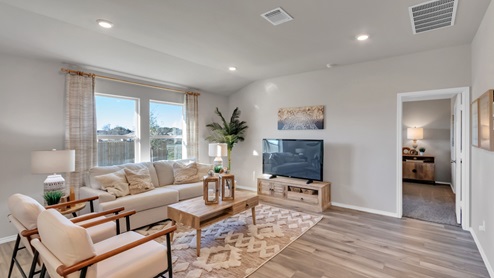 Pecan Creek model home living room with a view into the secondary room.