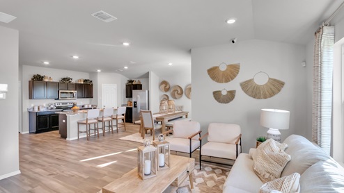 Pecan Creek model home open concept of living room with view of dining room and kitchen.