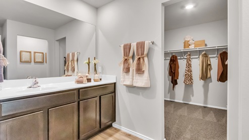 Pecan Creek model home primary bathroom with single vanity and mirror.
