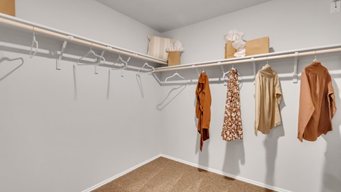 Pecan Creek model home primary closet with storage shelving.