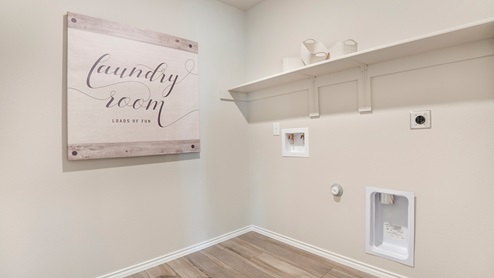 Pecan Creek Model Texas Cali utility room with washer and dryer connections with shelving for storage.