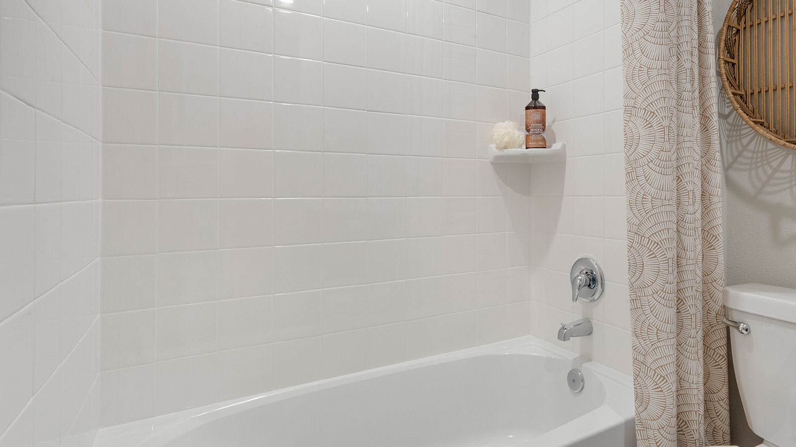 Pecan Creek Model Texas Cali secondary bathroom with shower and tub combo.