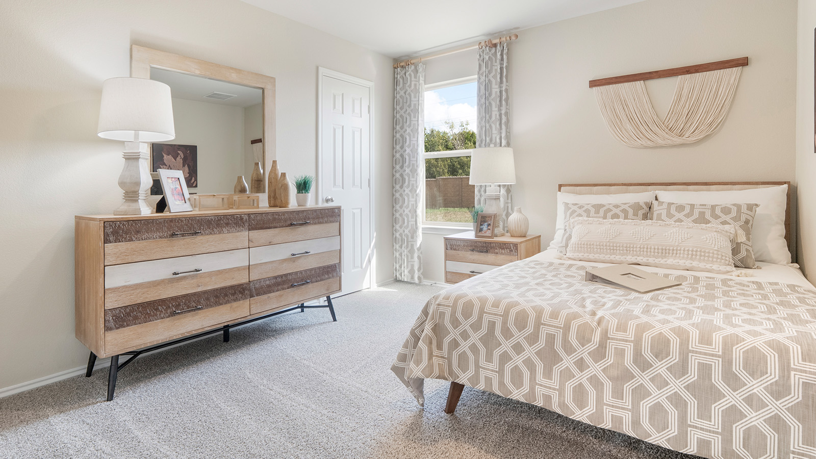 Pecan Creek Model Texas Cali secondary bedroom with carpeted flooring and window for lighting.