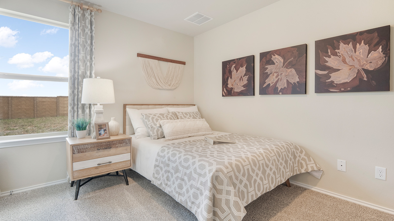 Pecan Creek Model Texas Cali secondary bedroom with carpeted flooring and window for lighting.