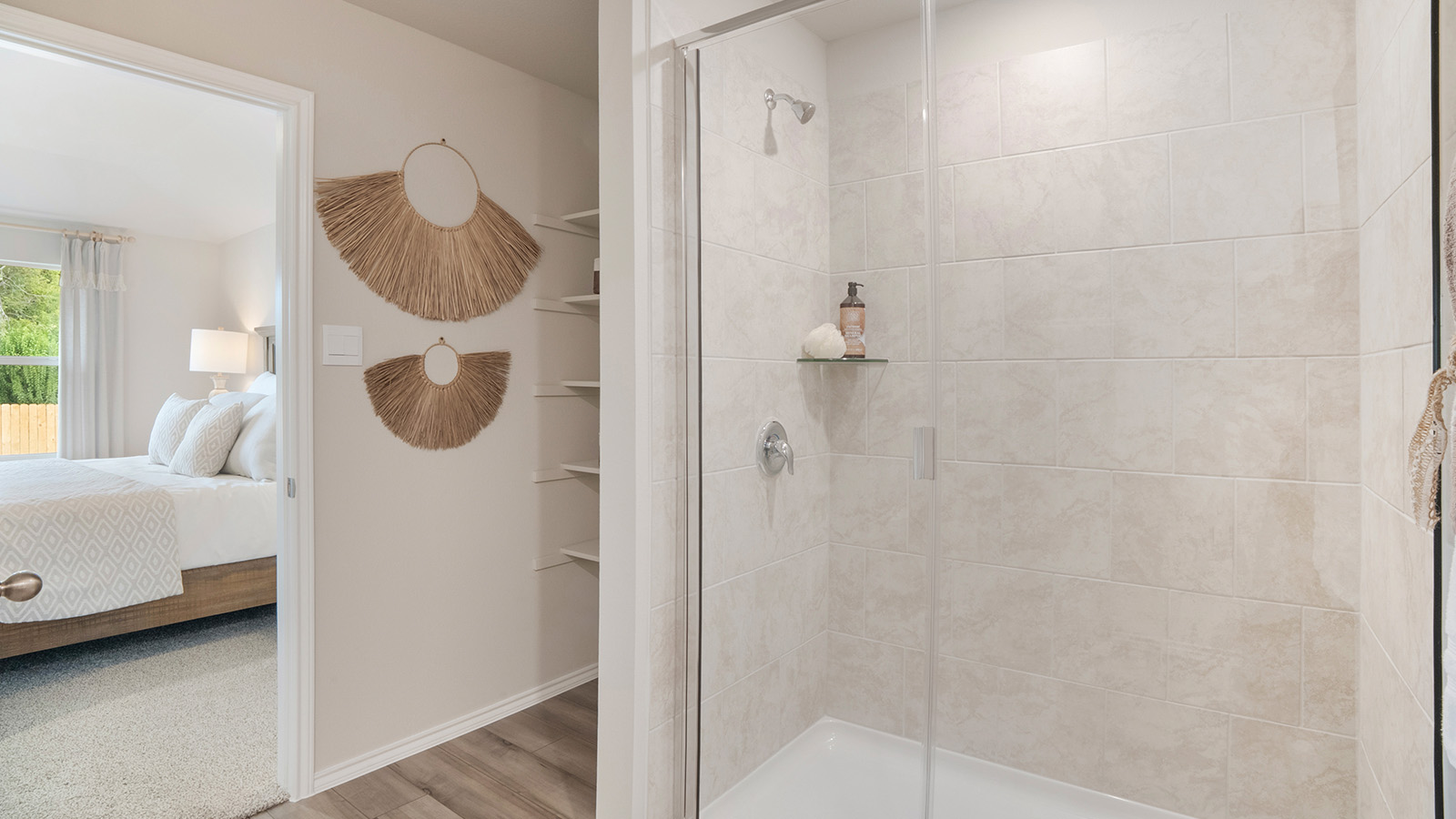 Pecan Creek Model Texas Cali primary bathroom with walk-in shower and shelving for storage.