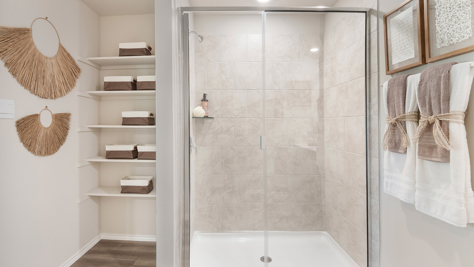 Pecan Creek Model Texas Cali primary bathroom with walk-in shower and shelving for storage.