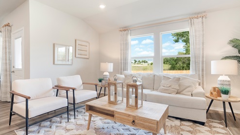 Pecan Creek Model Texas Cali living room with windows and view of back yard.