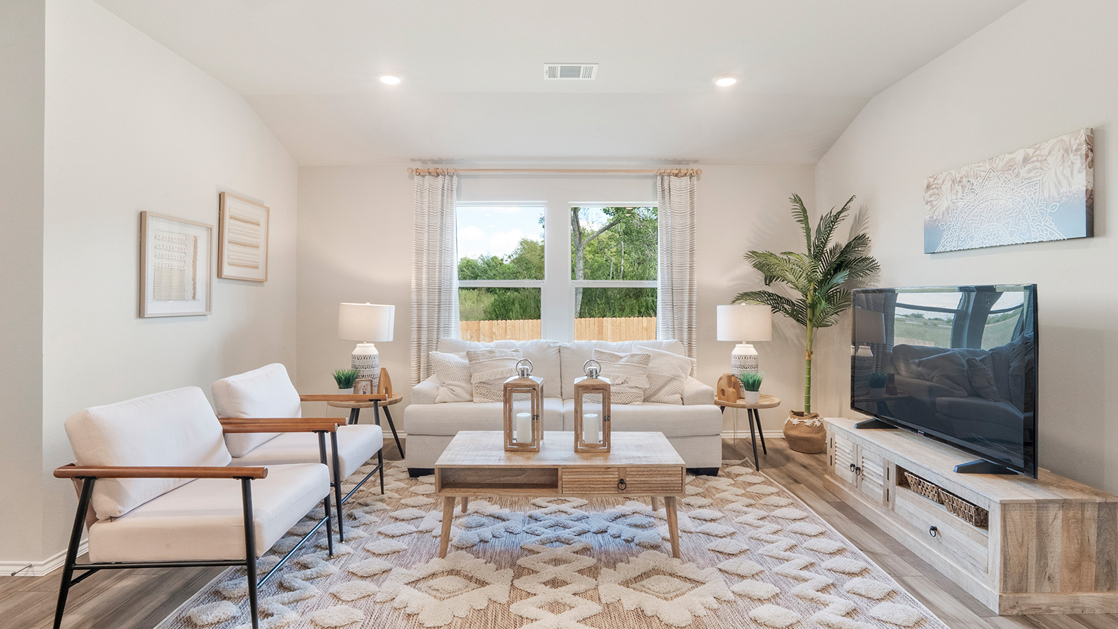 Pecan Creek Model Texas Cali living room with windows and view of back yard.