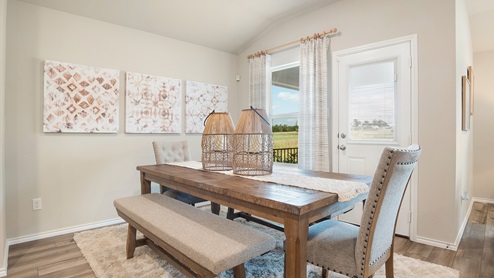 Pecan Creek Model Texas Cali dining room with view of back door and window to the back yard.