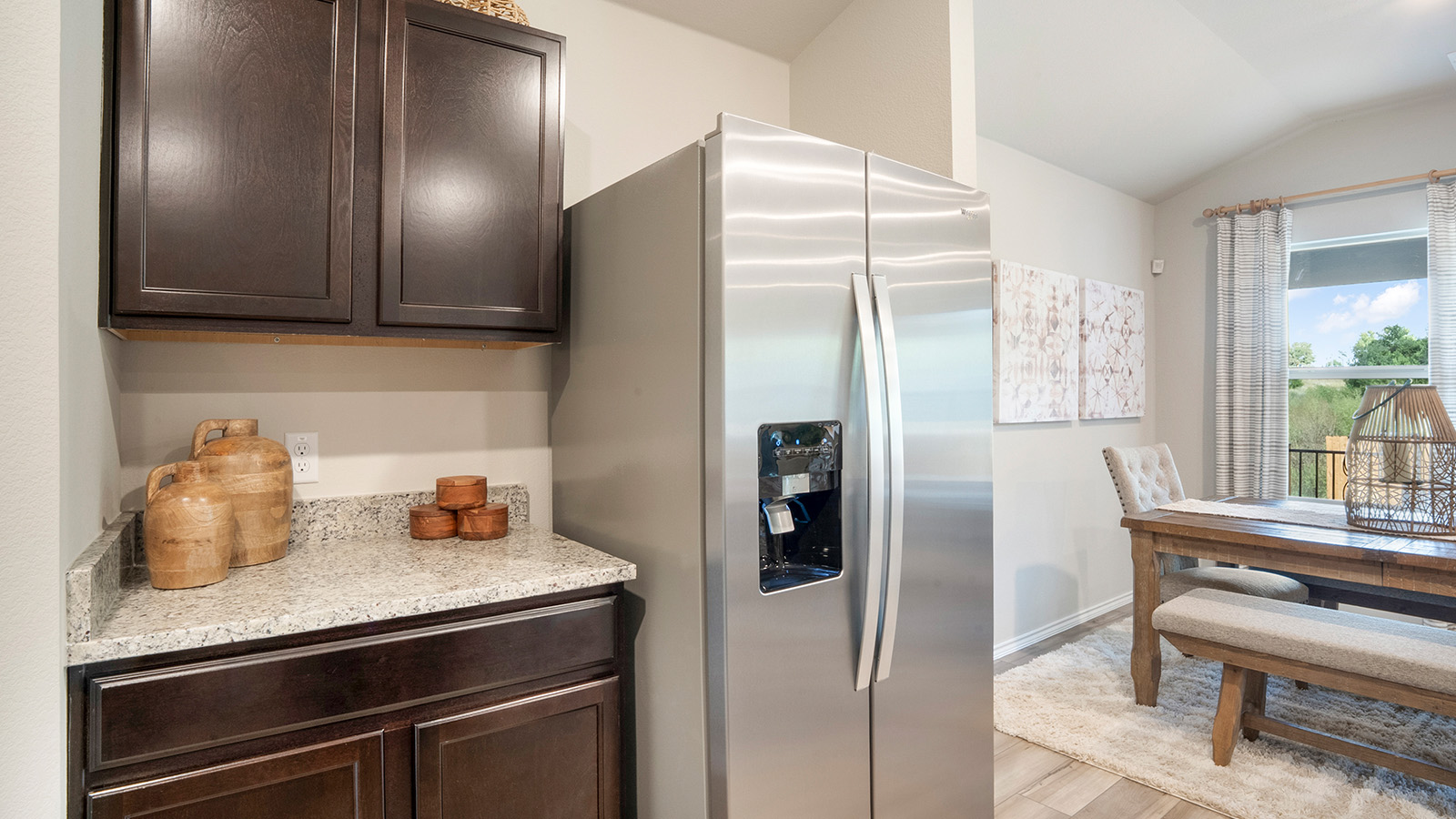 Pecan Creek Model Texas Cali kitchen with dark cabinets and granite countertops.
