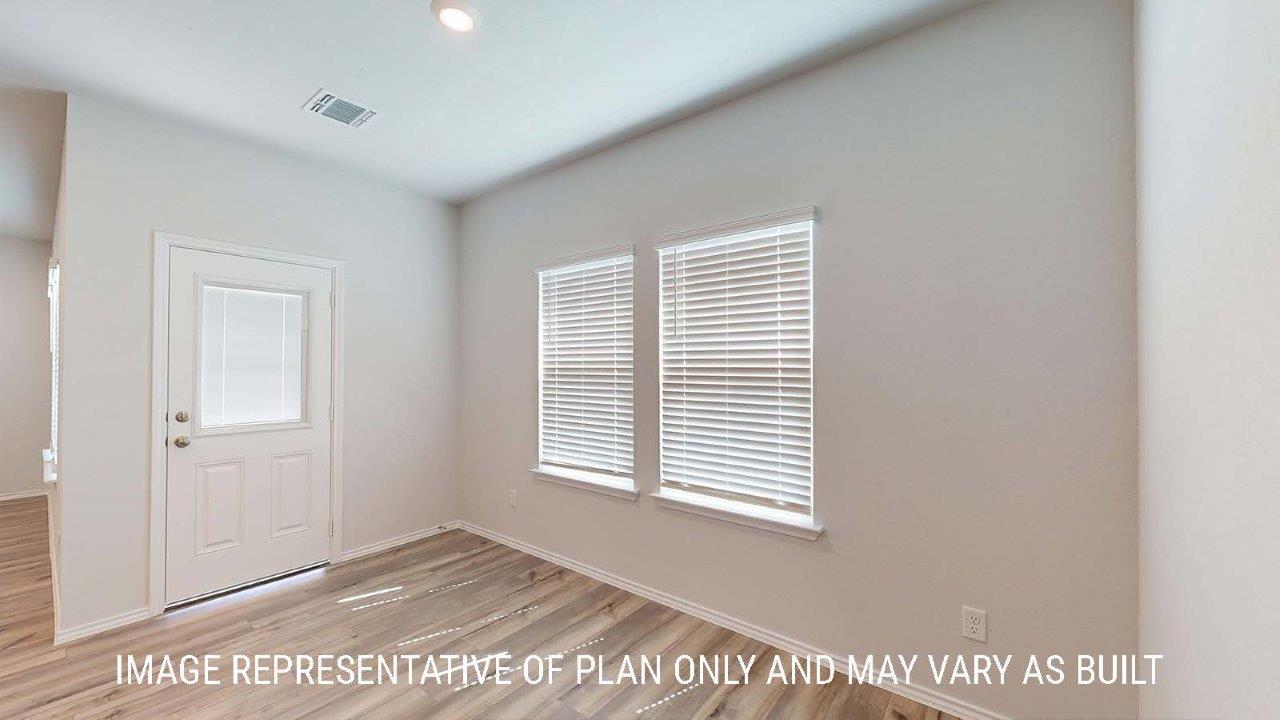 Emma kitchen with center kitchn island with granite countertops and view of dining room.