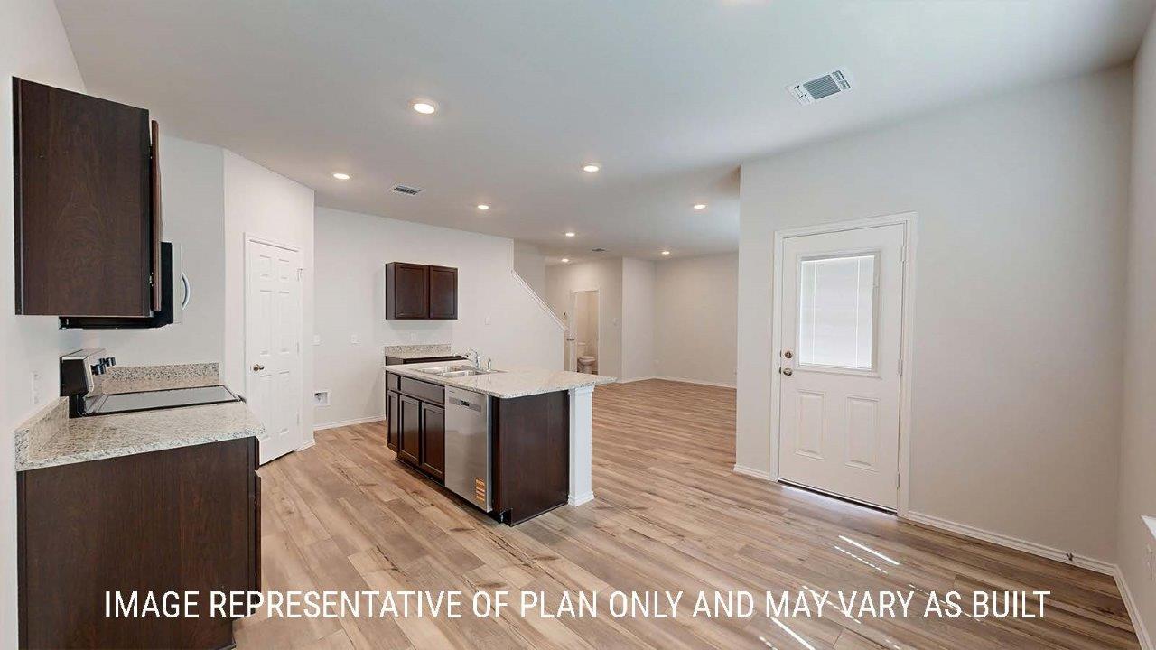 Emma dining room with vinyl plank flooring and view of back door and windows for lighting.