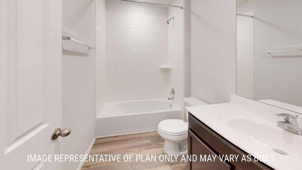 Emma secondary bathroom with vanity sink and bath tub and shower combo.