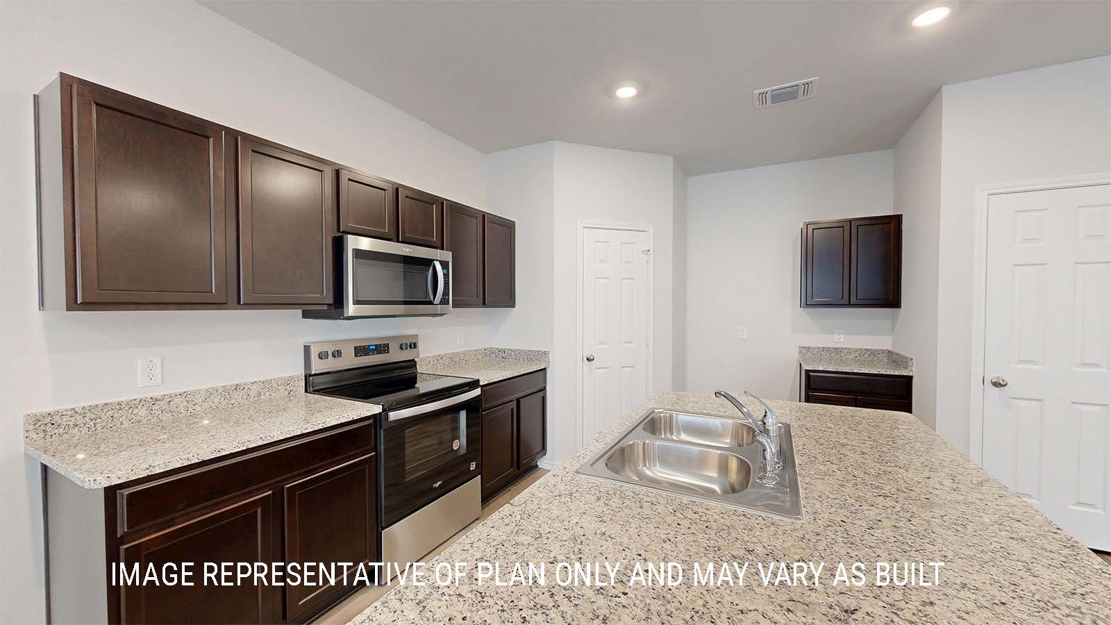Grace kitchen with dark cabinets and granite countertops.