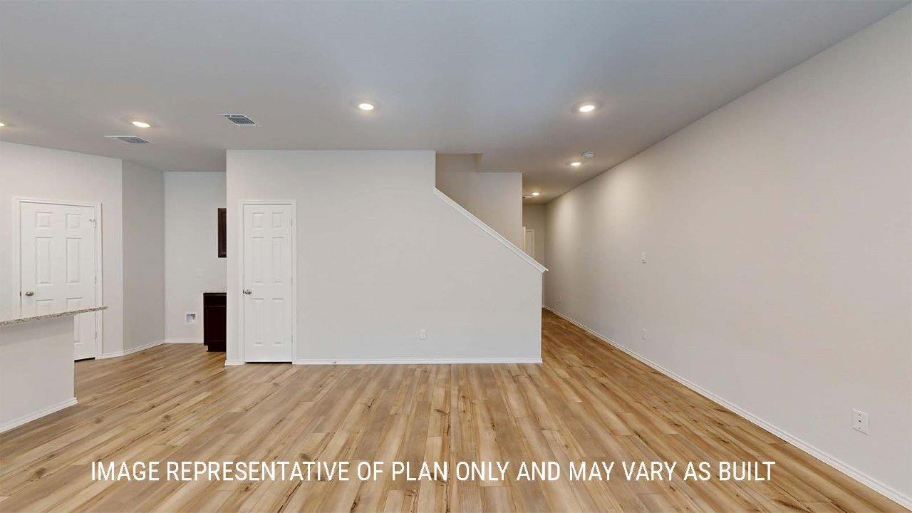 Grace entry with view of open concept living room and kitchen.