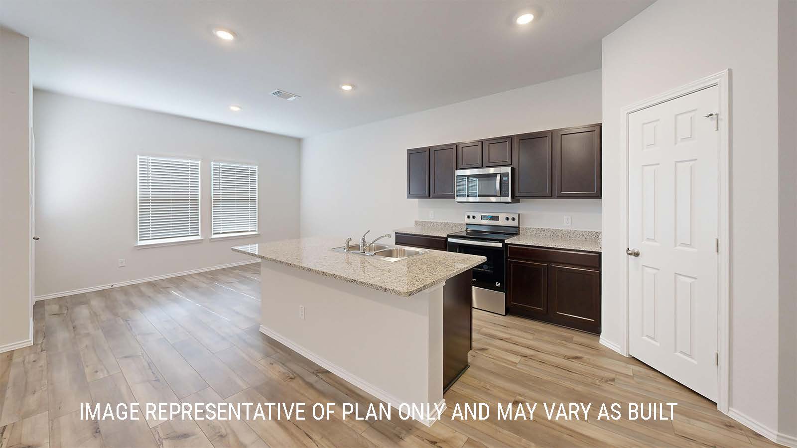 Grace kitchen with center kitchen island with granite countertops and view of dining room.