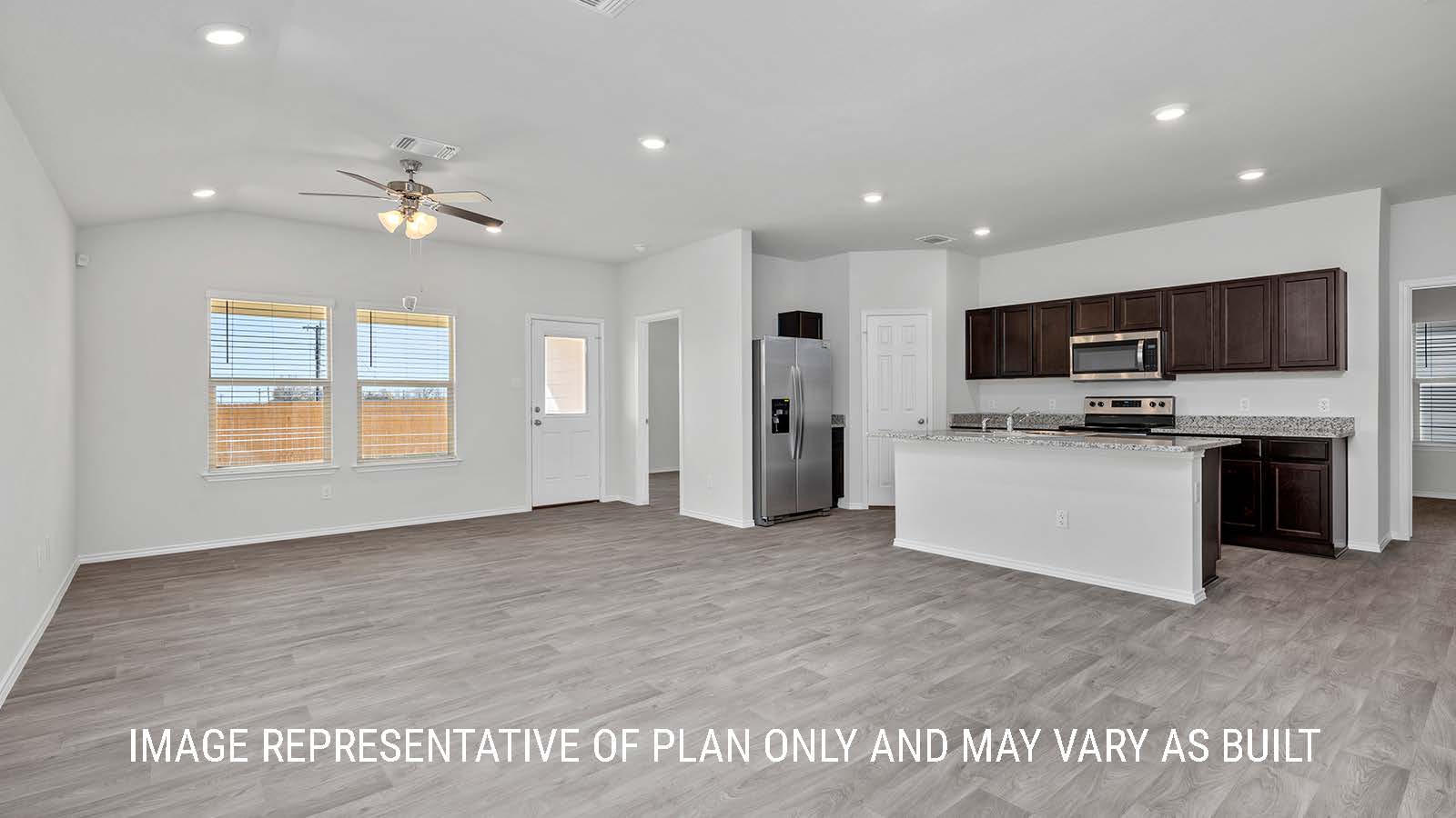 Camden living room with vinyl plank flooring and view of backyard.