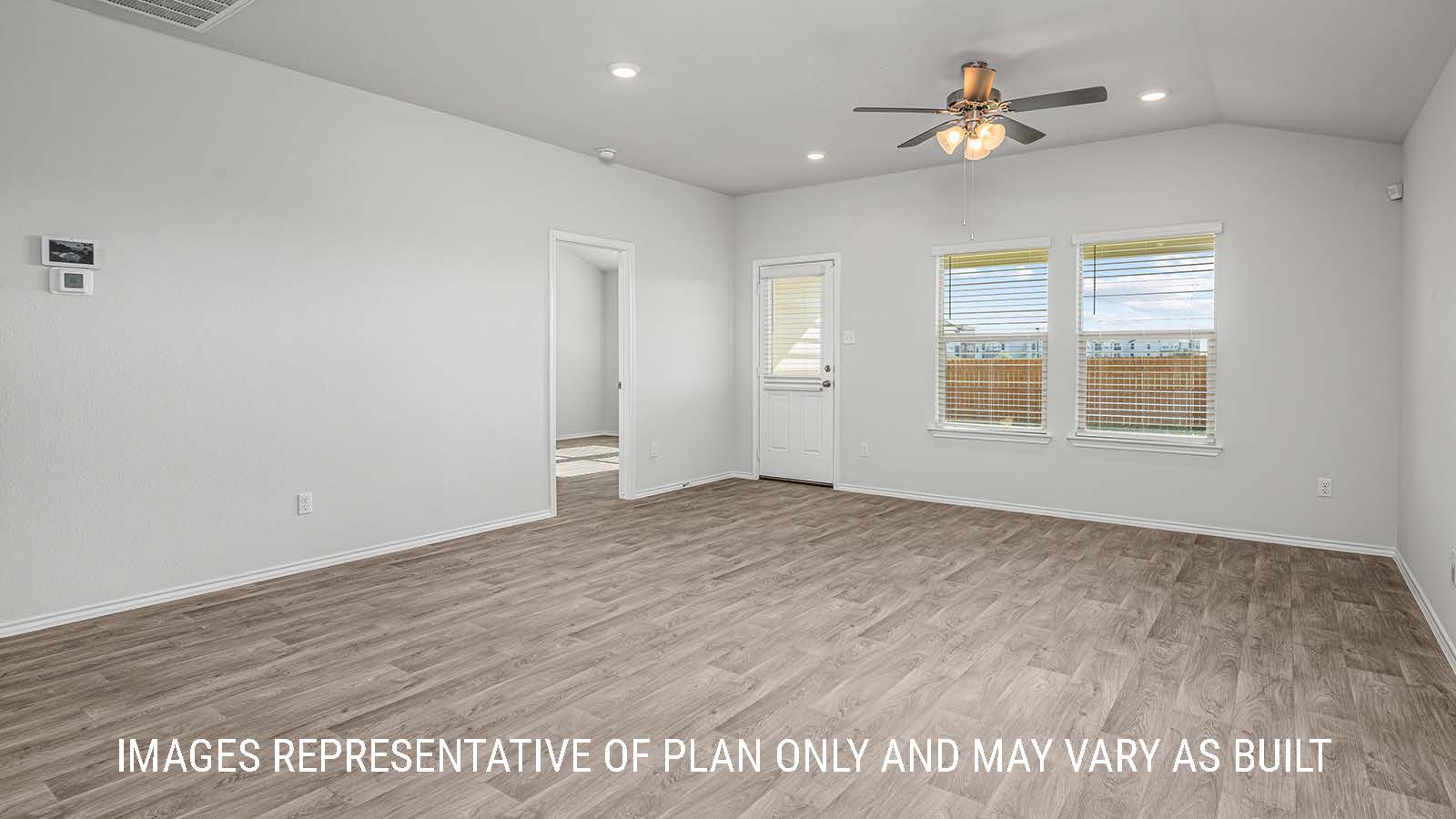 Elgin living room with vinyl plank flooring with windows and view of backyard.