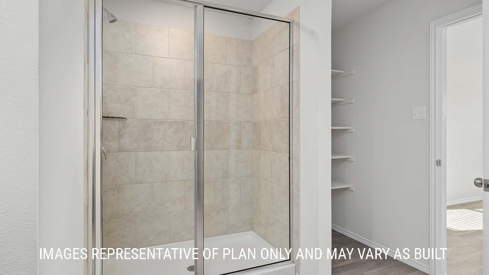 Texas Cali primary bathroom with walk-in shower and shelving for storage.