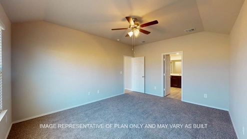 Texas Cali primary bedroom with carpet flooring and windows.