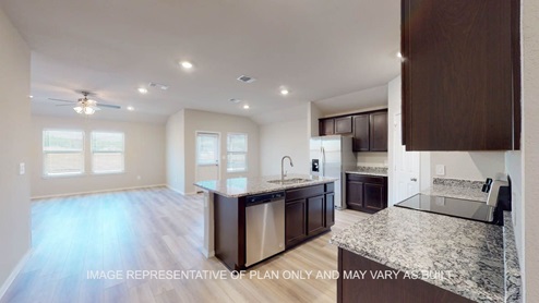 Texas Cali entry into kitchen with view to living and dining room living room.