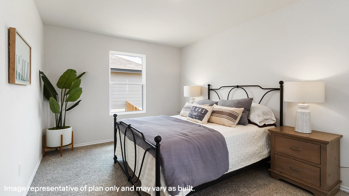 Atlanta primary bedroom with carpet flooring and window for natural lighting.