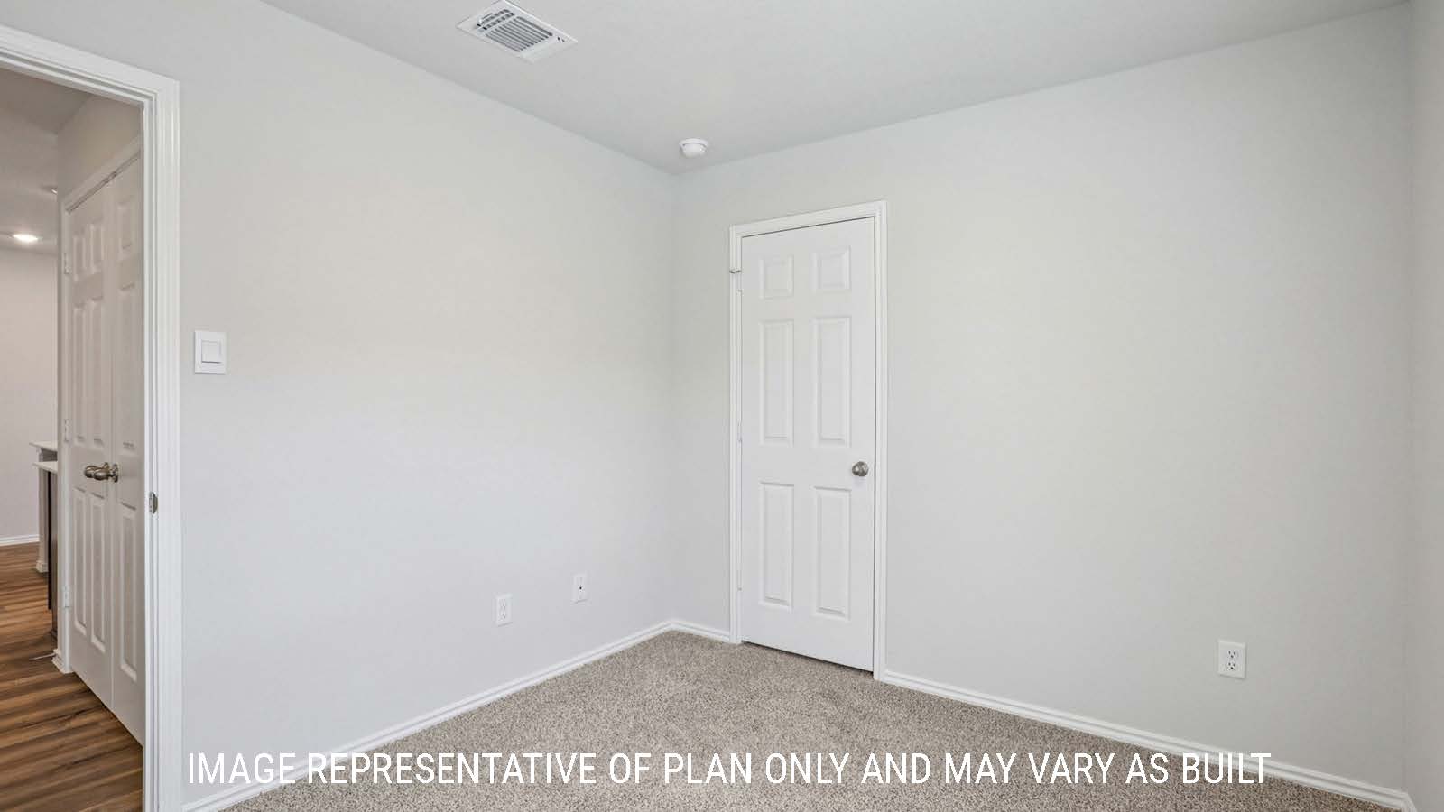 Atlanta secondary bedroom with carpeted flooring and window for lighting.