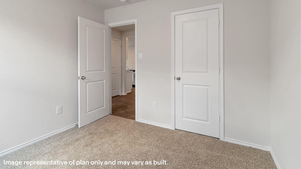 Atlanta secondary bedroom with carpeted flooring and closet door.