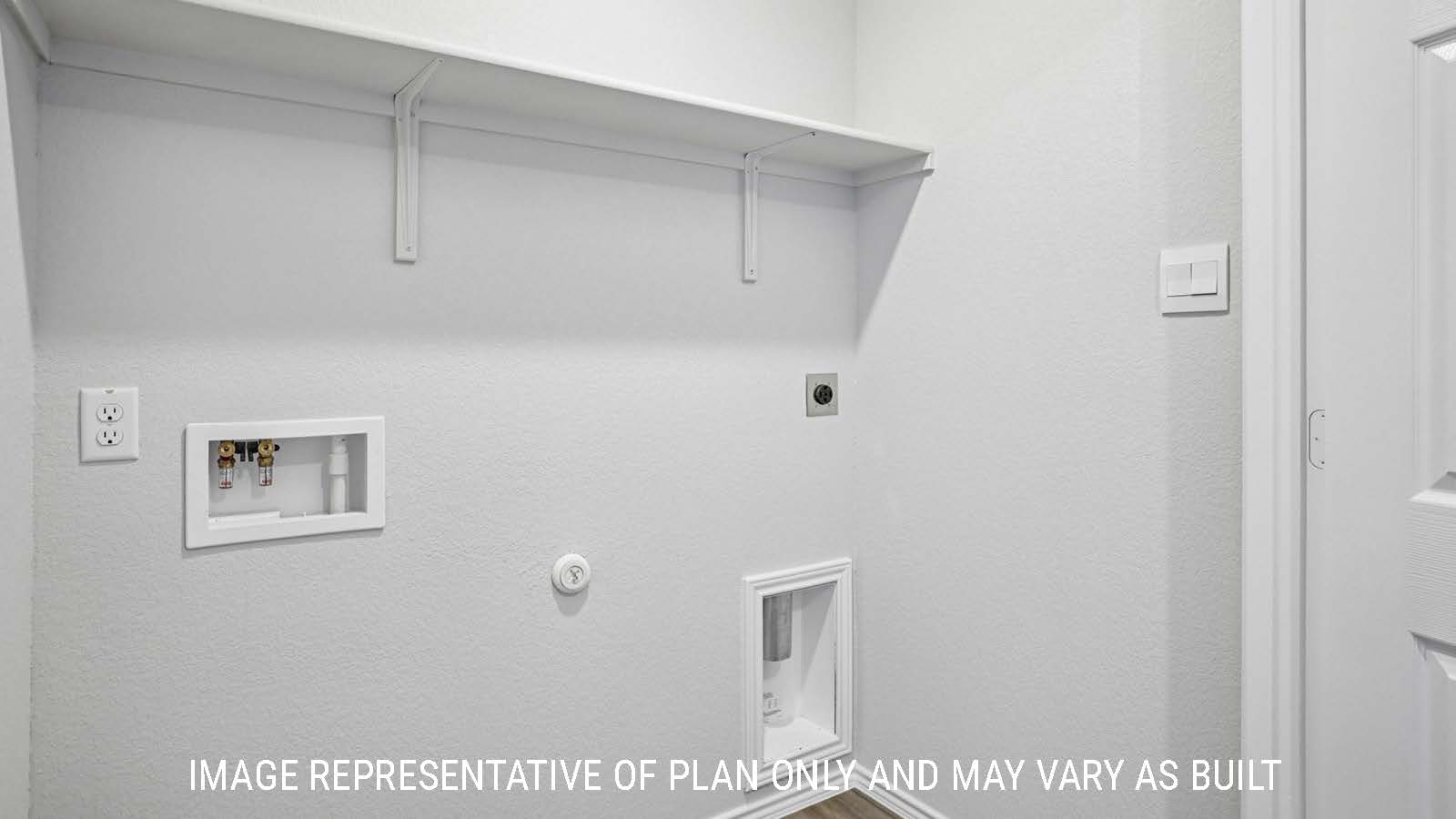 Atlanta utility room with washer and dryer connections and shelving for storage.