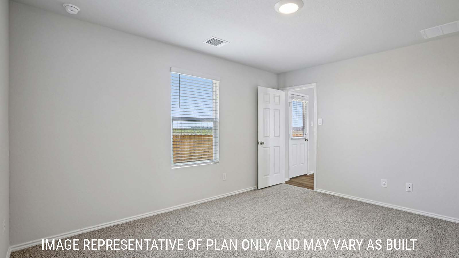 Barton primary bedroom with carpeted flooring and window for lighting.