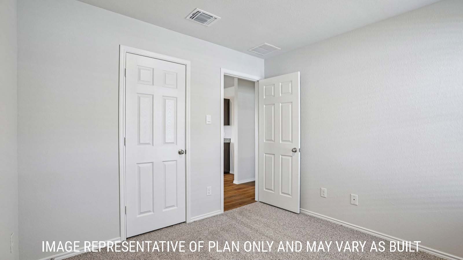Barton secondary bedroom with carpeted flooring and view of hallway.