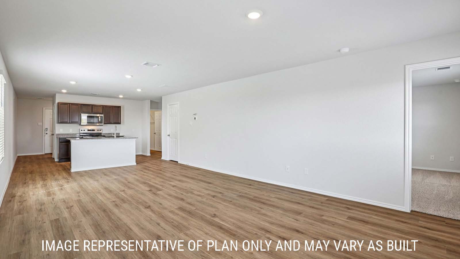 Barton dining room with vinyl plank flooring and view of open concept kitchen.