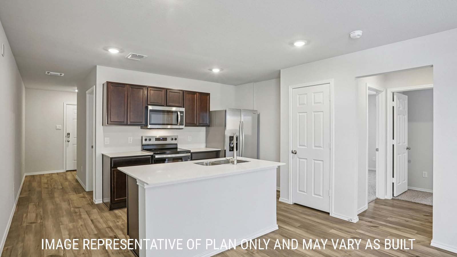 Caprock kitchen with kitchen island with granite countertops and view of entry way.