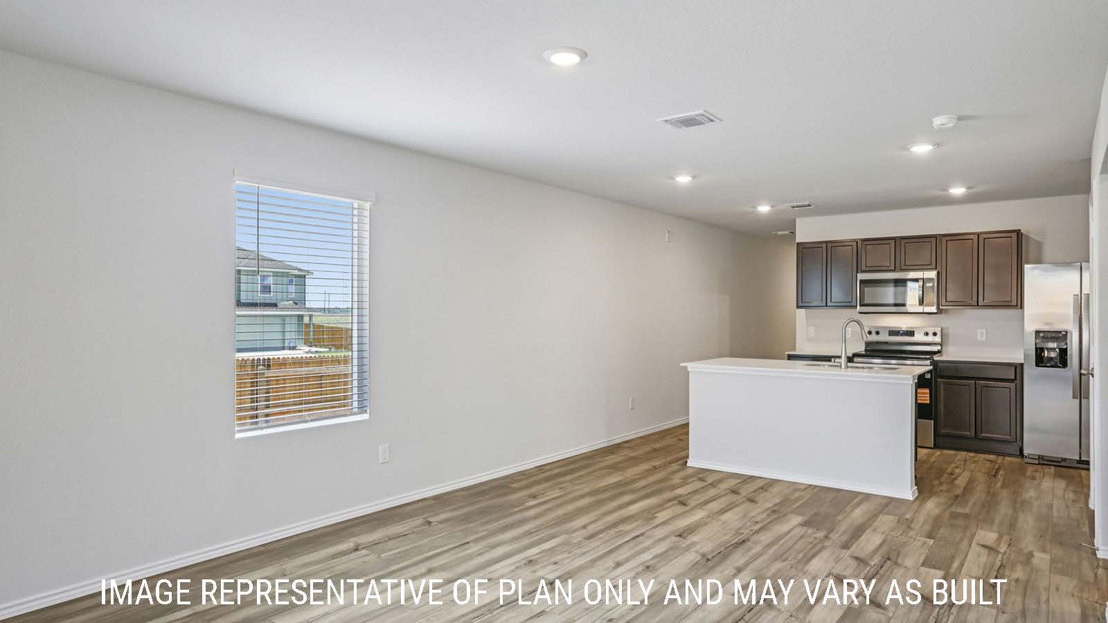 Caprock dining room with vinyl plank flooring and view of open concept kitchen.