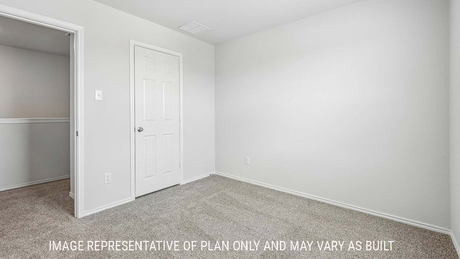 Davis secondary bedroom with carpeted flooring and view of hallway.