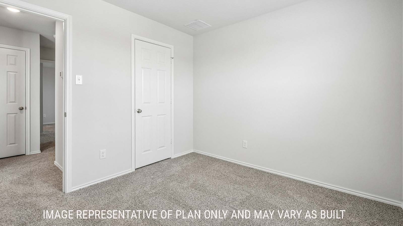 Davis secondary bedroom with carpeted flooring and view of hallway.