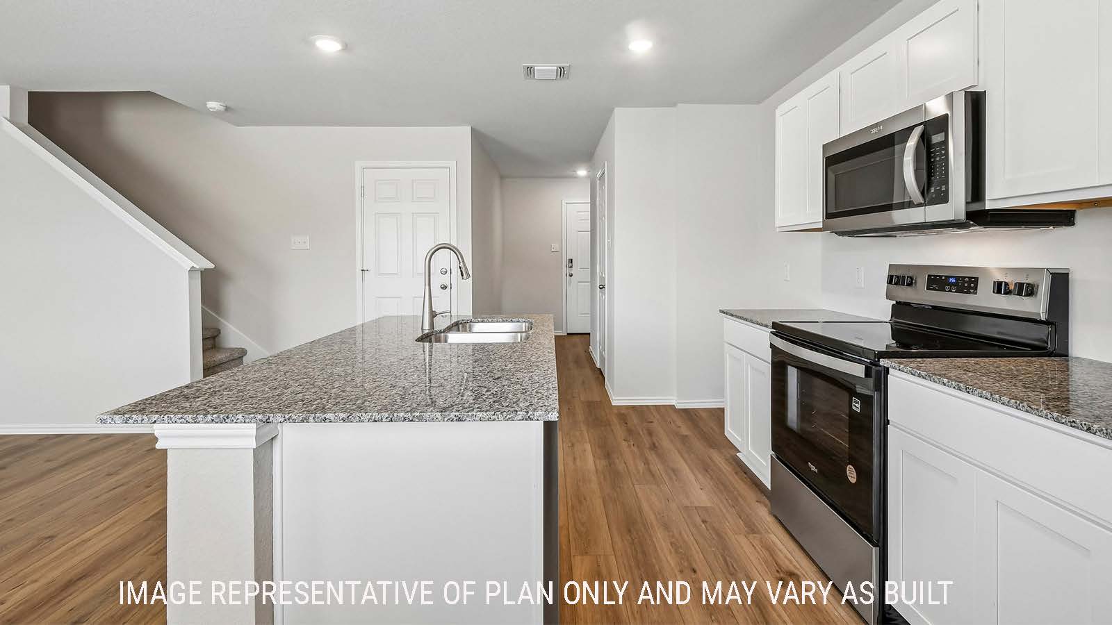 Davis kitchen with kitchen island and view of front entry way.