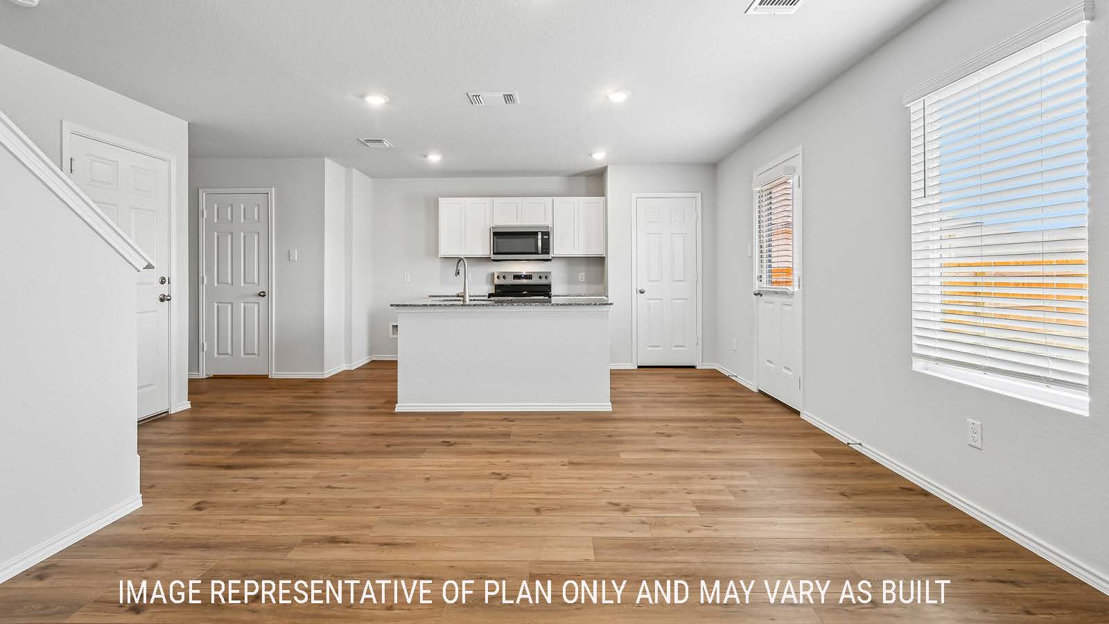 Davis kitchen with kitchen island and view of open concept dining room.
