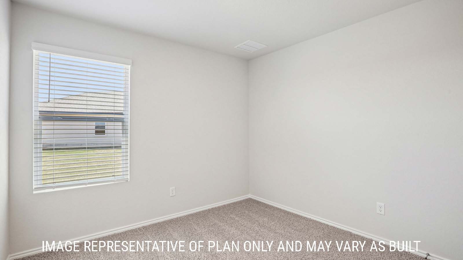 Estero secondary bedroom with carpeted flooring and window for natural lighting.