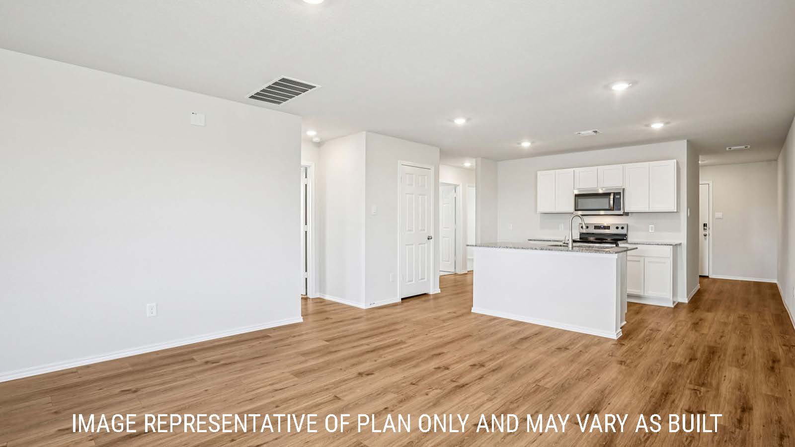 Estero dining room with vinyl plank flooring and view of open concept kitchen.