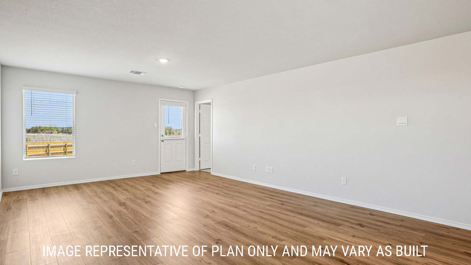 Estero living room with vinyl plank flooring and windows for natural lighting.