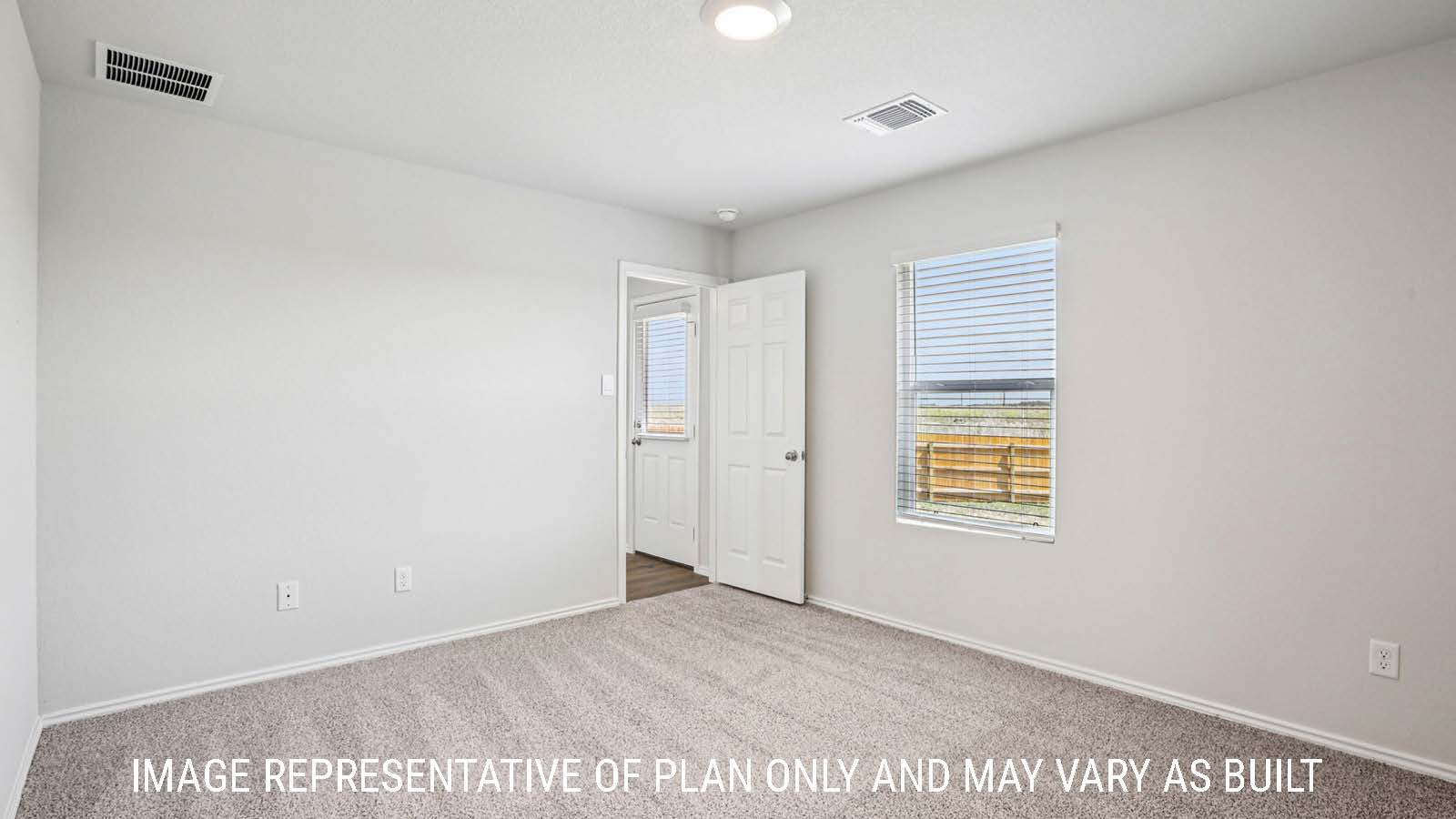 Estero primary bedroom with carpeted flooring and window for natural lighting.