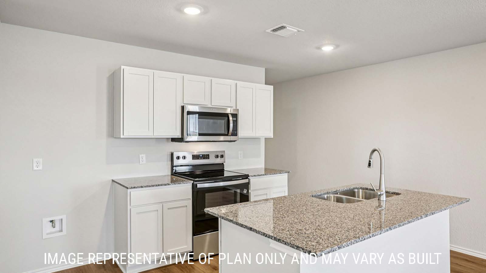 Estero kitchen with kitchen island with granite countertops and white cabinets.