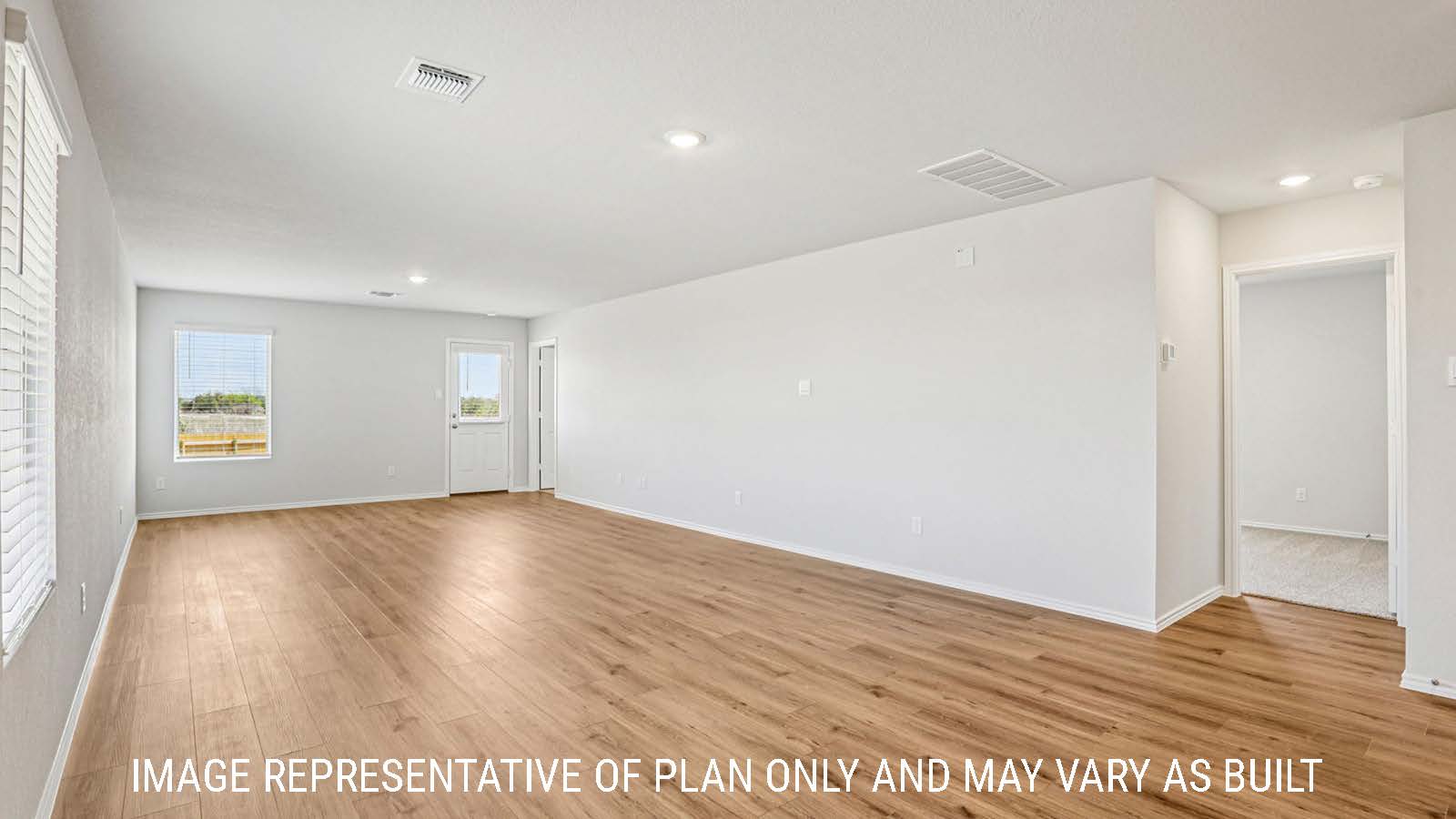 Estero dining room with view of open concept living room and window for lighting.