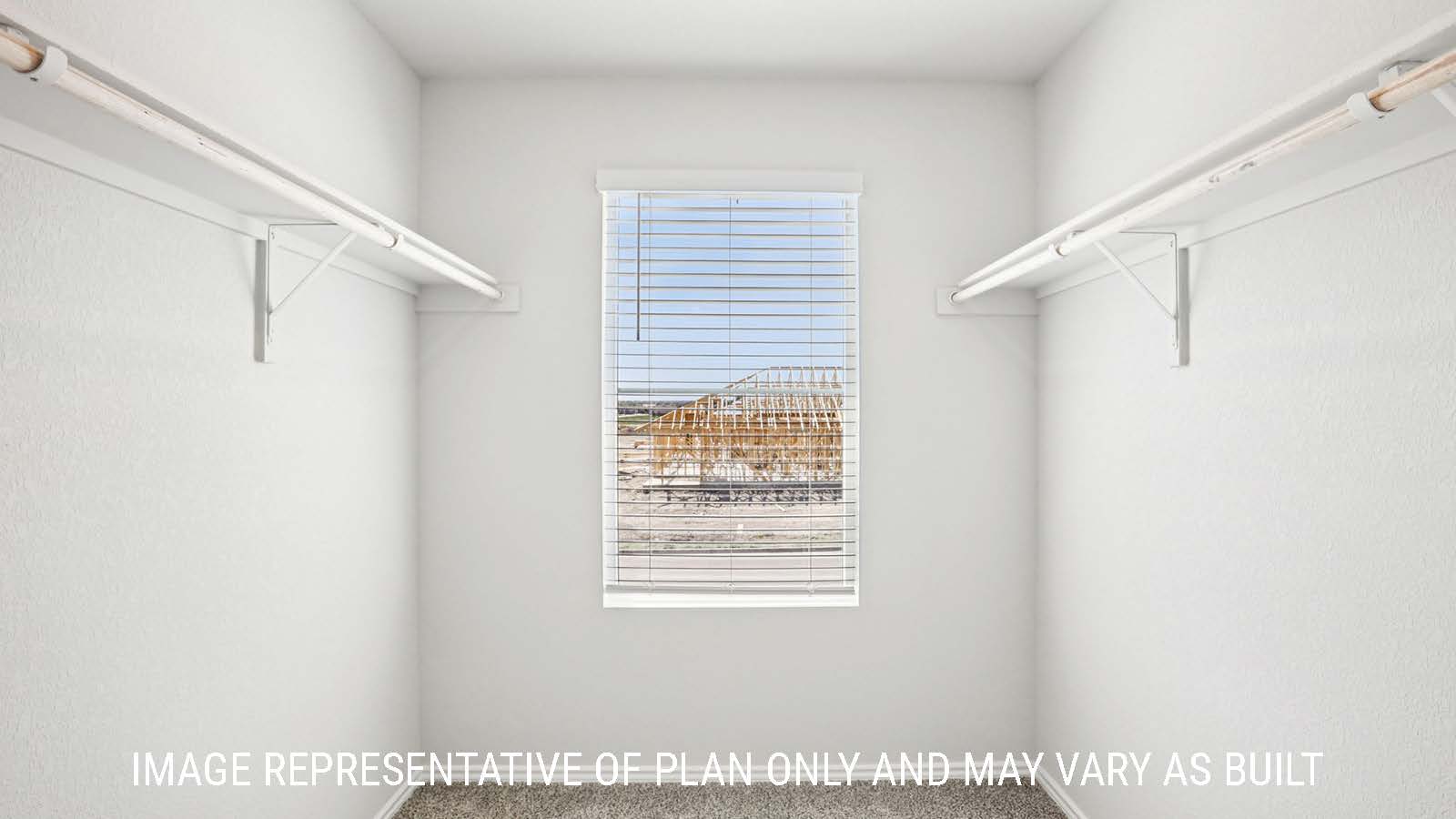 Franklin primary bedroom closet with shelving for storage and window for natural lighting.