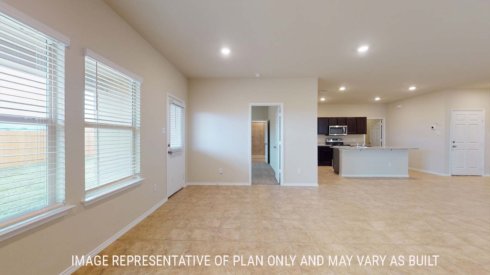 Perry living room with windows for natural lighting and view of open concept kitchen and primary bedroom.
