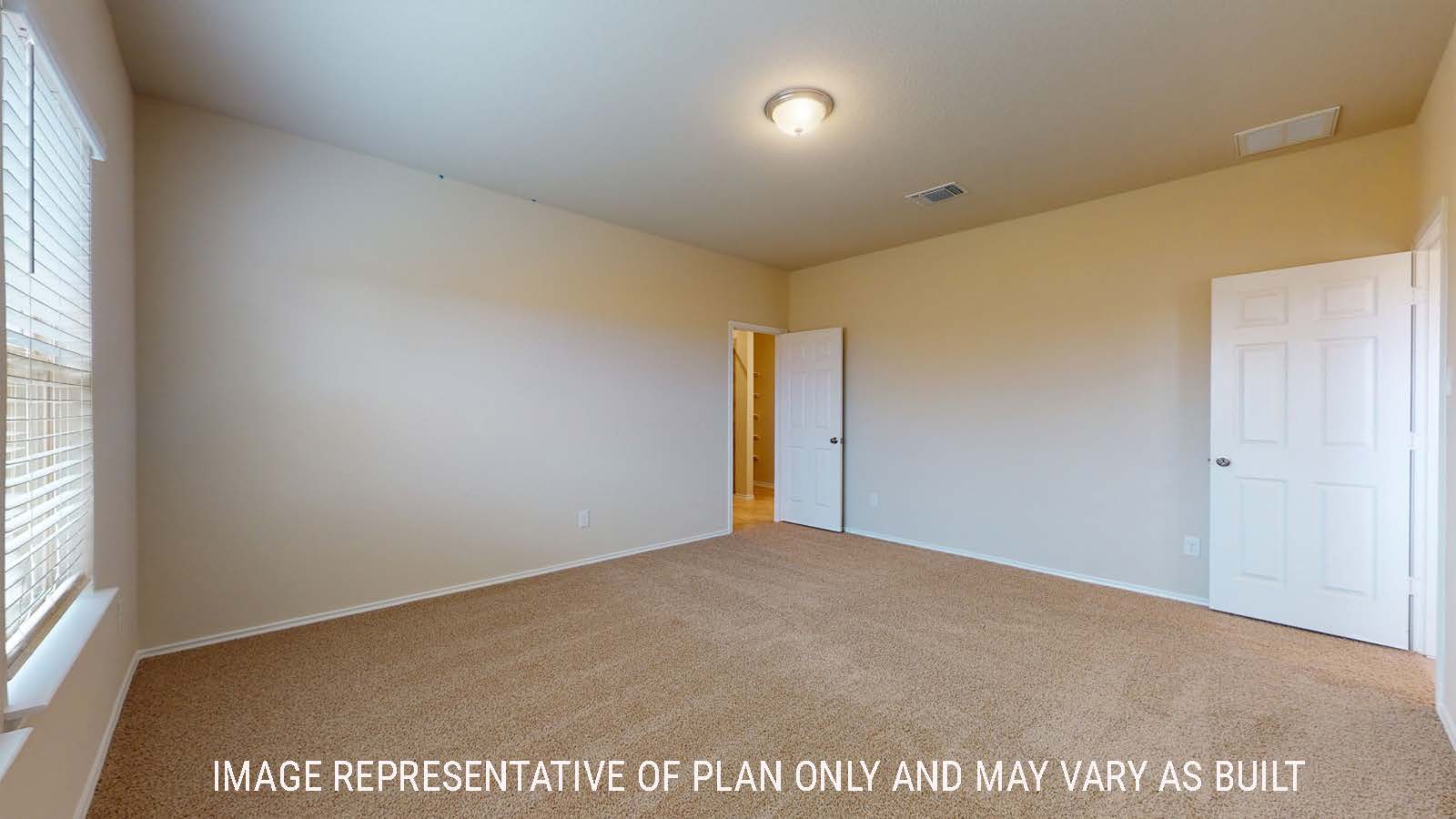 Perry primary bedroom with carpeted flooring and windows for natural lighting and view of primary bathroom.