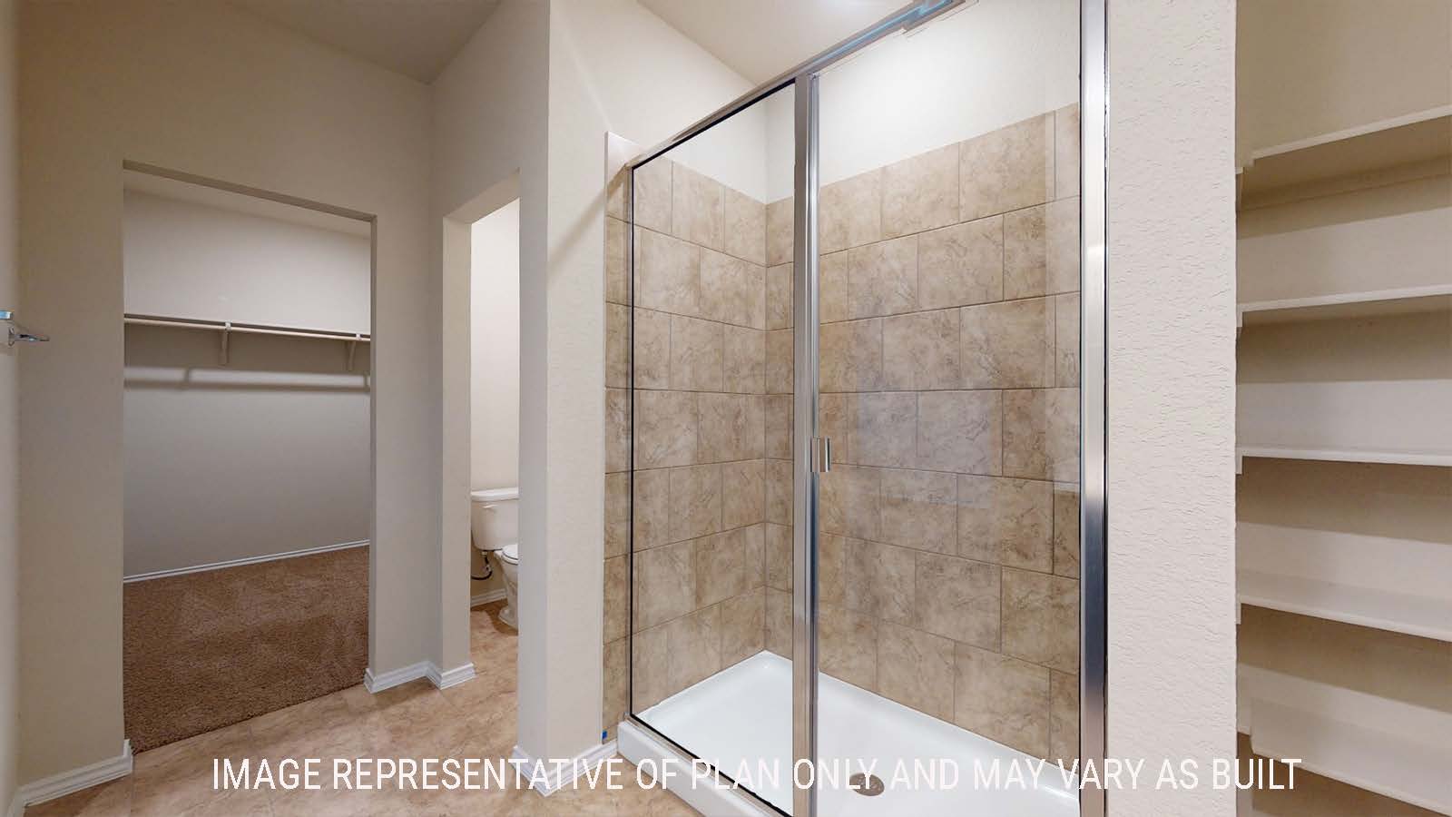 Perry primary bathroom with walk-in shower and view of walk-in closet.